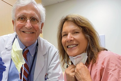 John Glick, MD, emeritus professor of Hematology/Oncology, smiles for a selfie photo taken with and by Lu Ann Cahn, former TV reporter, during her last oncology medical appointment as Glick's patient in 2020.